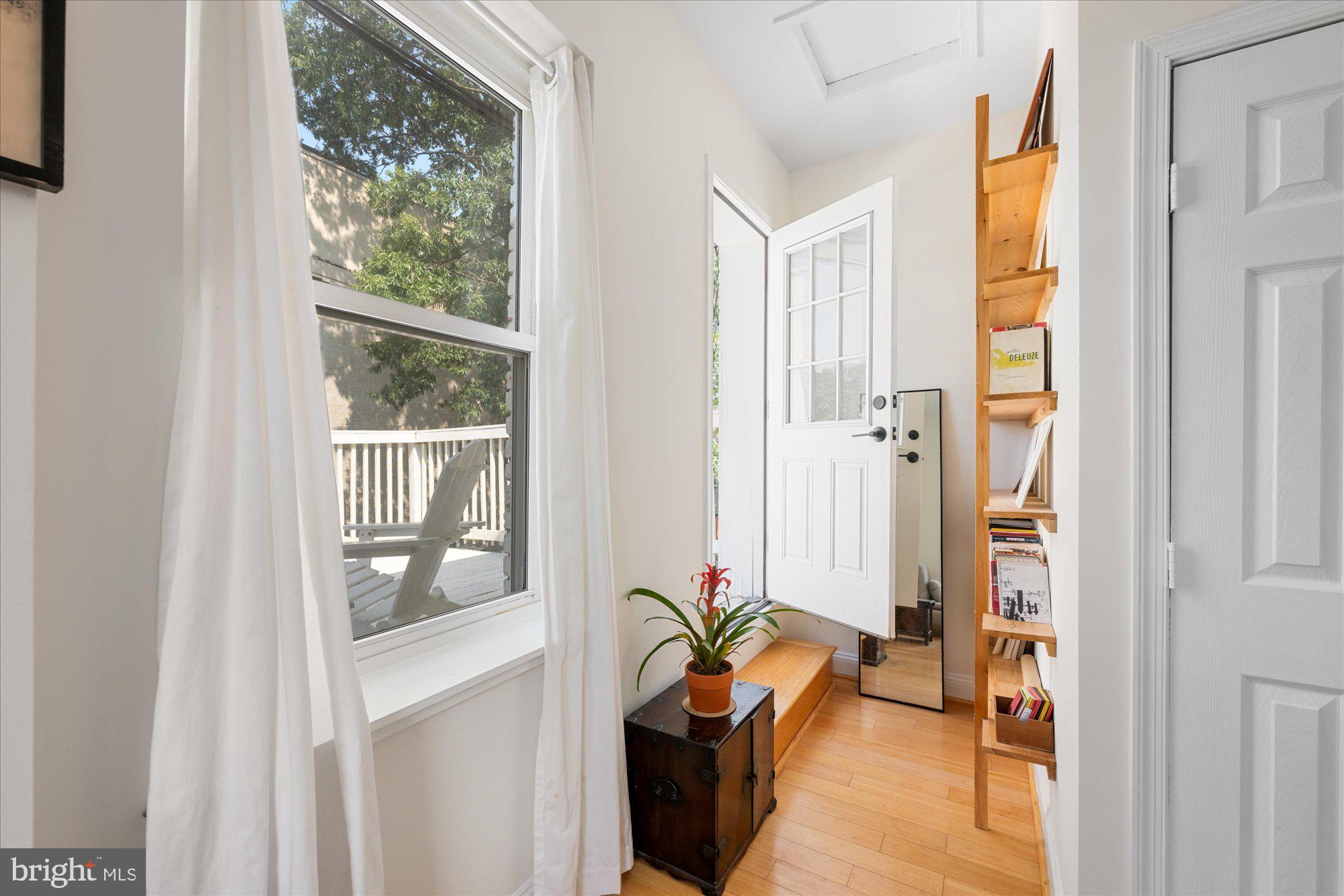 1124 E Street Northeast, Unit A Washington, DC 20002 - Photo 8 of 10 a living room with furniture and a window