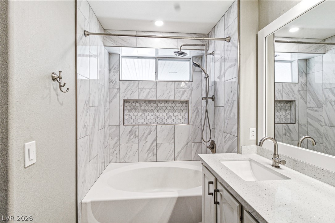 9523 Observer Street Las Vegas, NV 89123 - Photo 32 of 42 A well-appointed bath offers a sleek vanity, elegant tile work, and an inviting bathtub/shower combination.