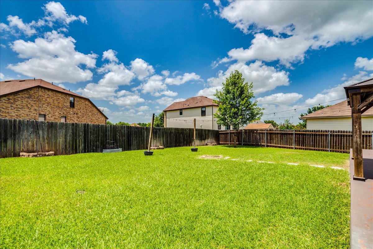401 Waterleaf Boulevard Kyle, TX 78640 - Photo 25 of 28 Huge backyard with a patio the width of the home with a gazebo.