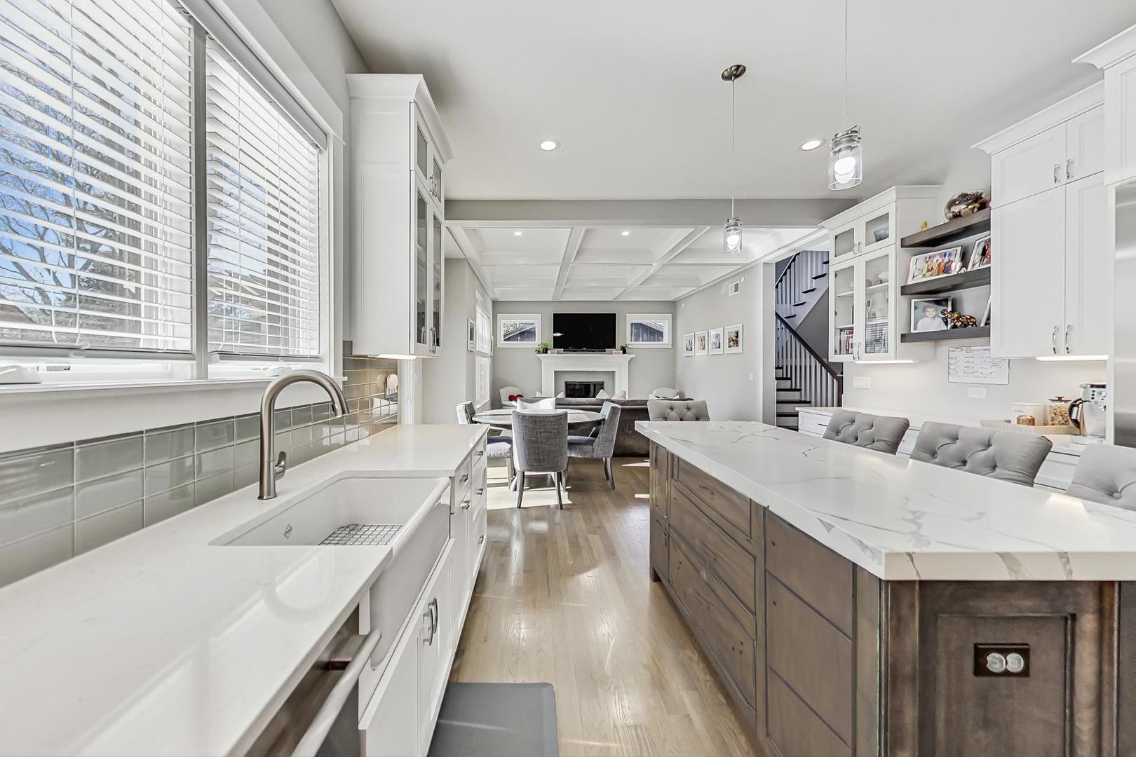 2425 Illinois Road Northbrook, IL 60062 - Photo 12 of 59 a large white kitchen with a large window and stainless steel appliances