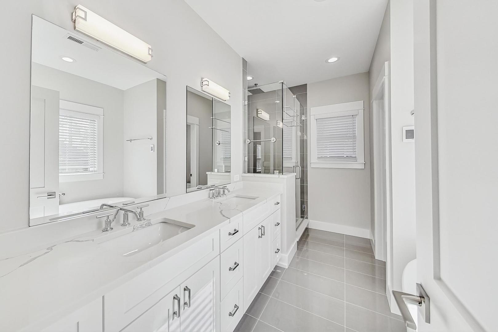 2425 Illinois Road Northbrook, IL 60062 - Photo 27 of 59 a bathroom with double vanity sinks and a mirror