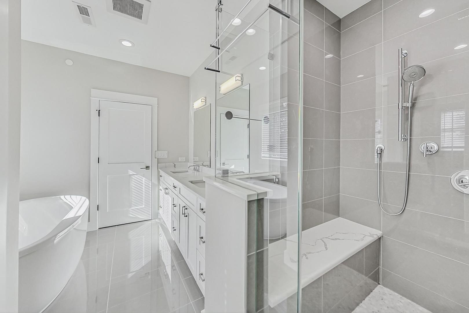 2425 Illinois Road Northbrook, IL 60062 - Photo 28 of 59 a spacious bathroom with a granite countertop sink a toilet a shower and a mirror