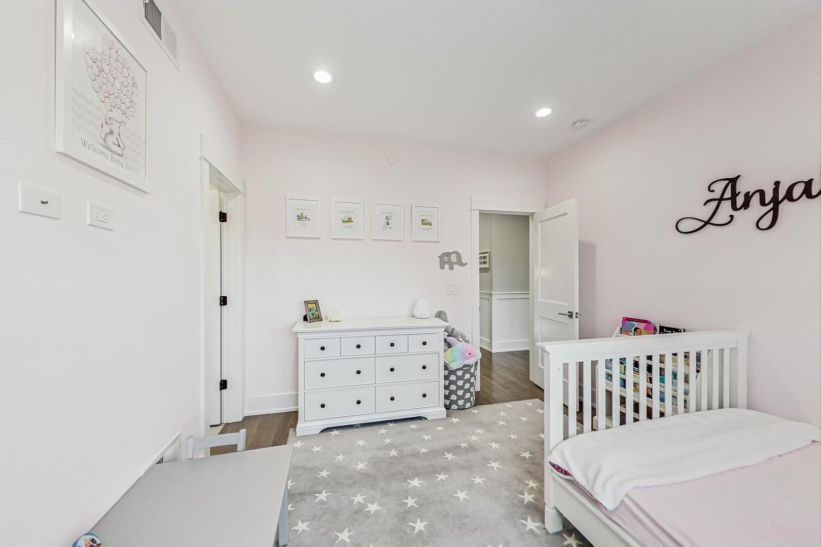 2425 Illinois Road Northbrook, IL 60062 - Photo 30 of 59 a bedroom with a bed and cabinets