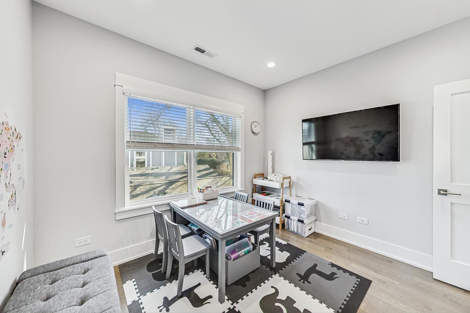 2425 Illinois Road Northbrook, IL 60062 - Photo 34 of 59 a living room with a flat screen tv and a window