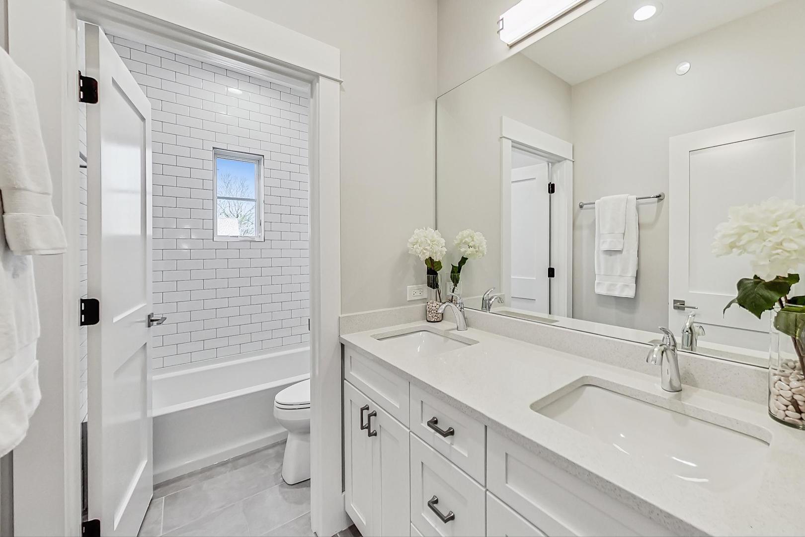2425 Illinois Road Northbrook, IL 60062 - Photo 36 of 59 a bathroom with a granite countertop sink toilet and shower
