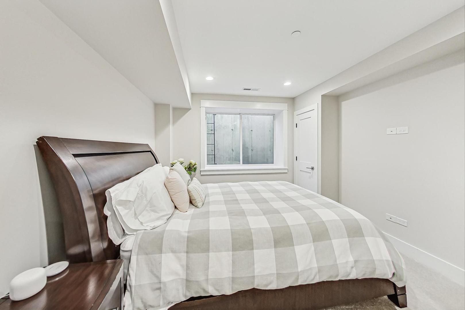 2425 Illinois Road Northbrook, IL 60062 - Photo 43 of 59 a bedroom with a bed and wooden floor