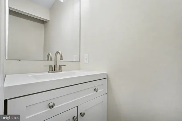 a bathroom with a sink and vanity