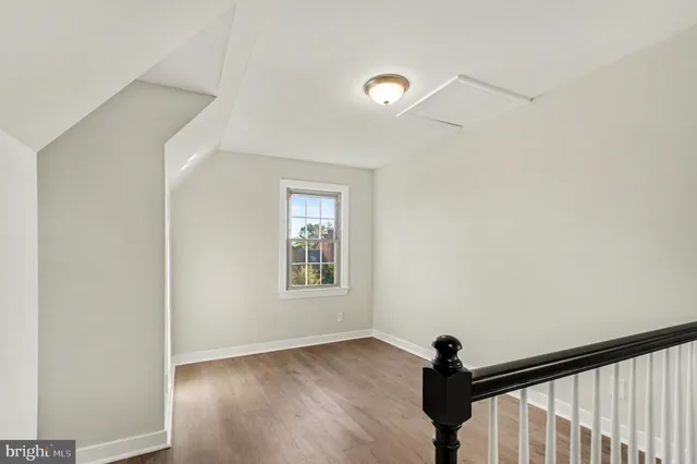 a view of hallway with wooden floor and stairs