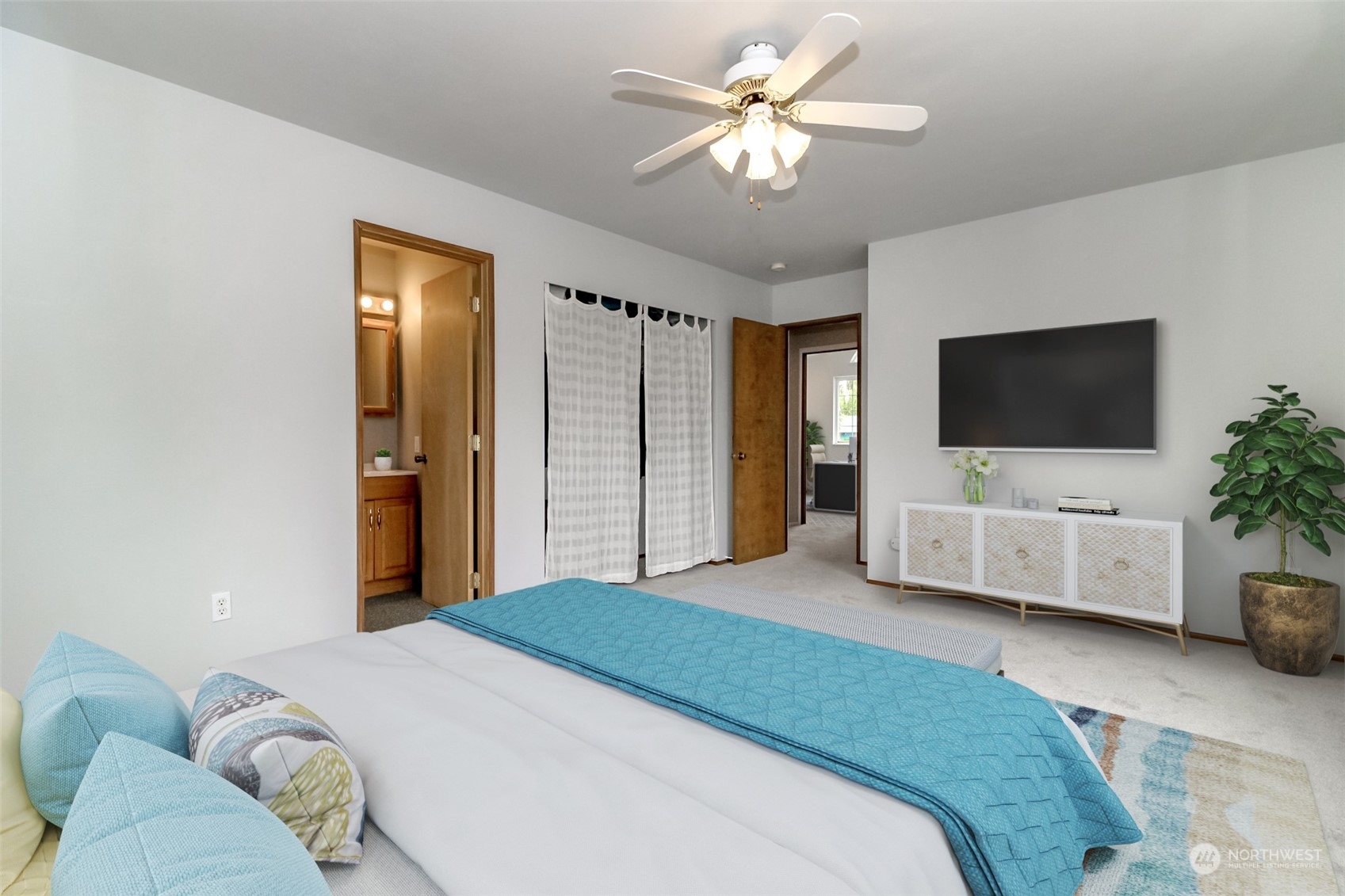 2401 Northeast 27th Street Renton, WA 98056 - Photo 13 of 24 a spacious bedroom with a bed and a flat screen tv