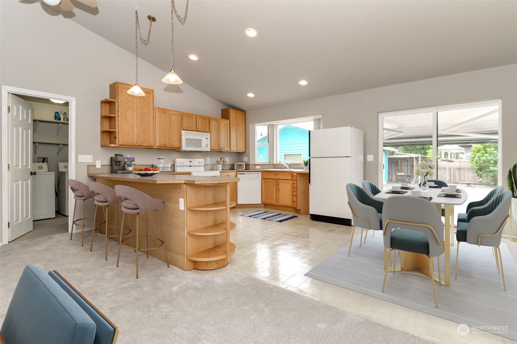 2401 Northeast 27th Street Renton, WA 98056 - Photo 8 of 24 a kitchen with stainless steel appliances granite countertop a stove top oven a sink dishwasher a dining table and chairs with wooden floor