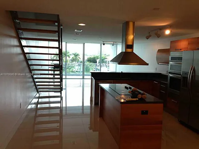 a bathroom with a granite countertop toilet a sink and shower