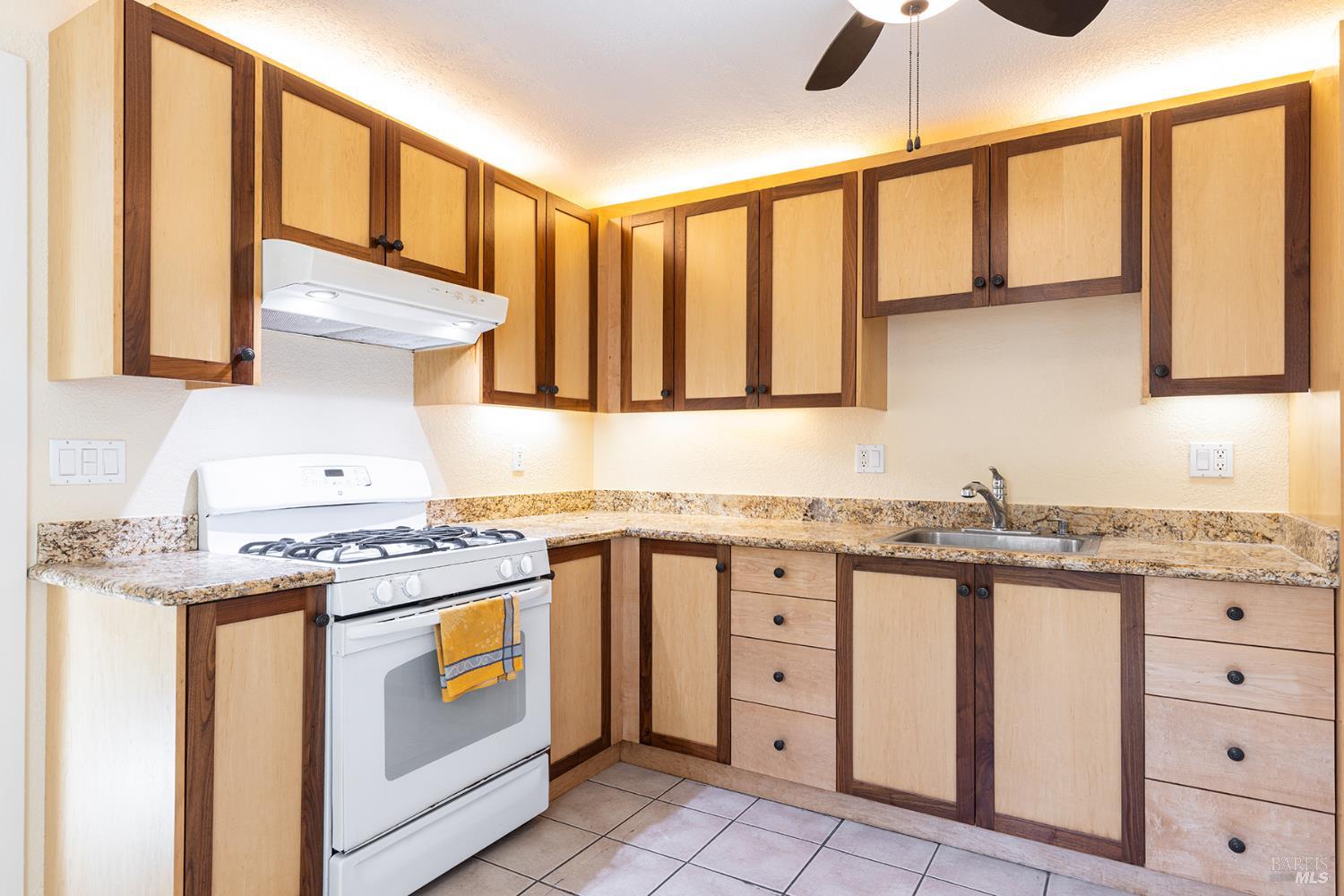 18090 Las Lomas Road Sonoma, CA 95476 - Photo 5 of 37 a kitchen with granite countertop a stove a sink and a cabinets