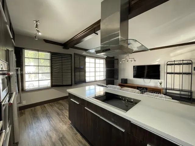 a kitchen with a sink appliances and a window