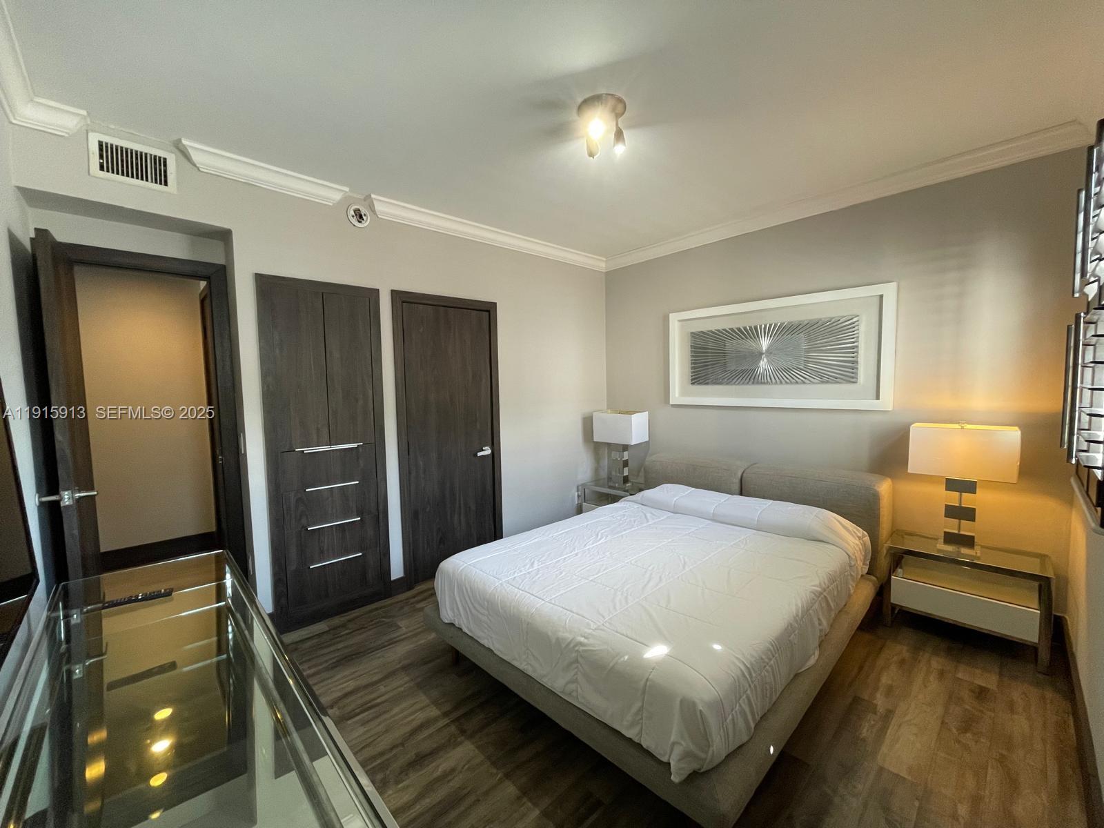 610 8th Street, Unit 101 Miami Beach, FL 33139 - Photo 12 of 17 a bedroom with a bed and a walk in closet