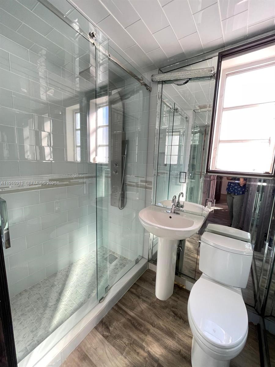 610 8th Street, Unit 101 Miami Beach, FL 33139 - Photo 7 of 17 a bathroom with a sink toilet and shower