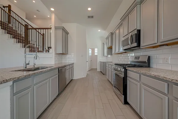a view of a kitchen with furniture and a ceiling fan