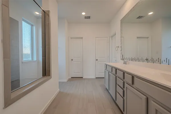 an empty room with a window and a fan