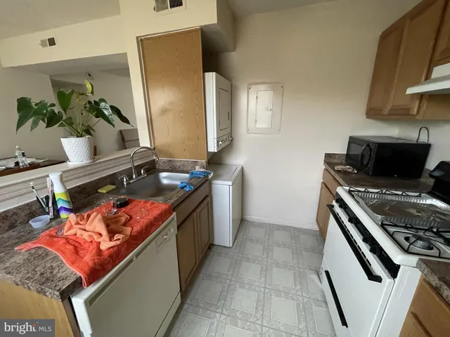 a kitchen with stainless steel appliances granite countertop a stove and a sink