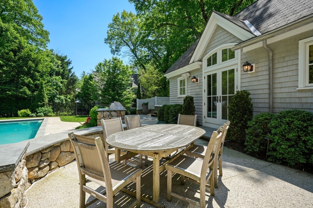 70 Old Farm Road Wellesley, MA 02481 - Photo 30 of 38 a view of a patio with table and chairs with wooden fence and plants