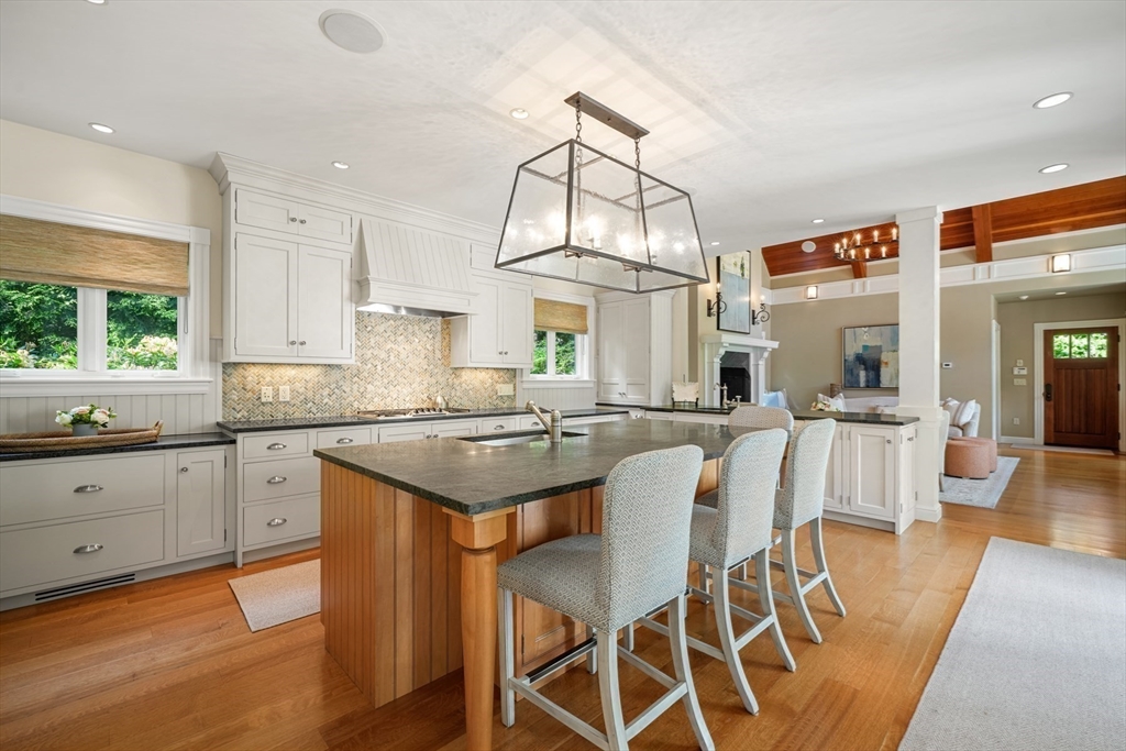 70 Old Farm Road Wellesley, MA 02481 - Photo 6 of 38 a kitchen with stainless steel appliances granite countertop a table and chairs in it