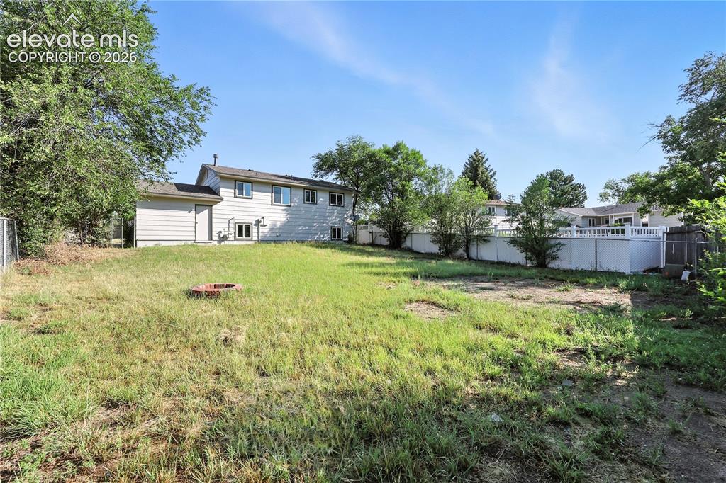 7033 Sequoyah Way Colorado Springs, CO 80915 - Photo 20 of 20 a view of a house with a yard and tree s