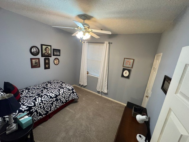 9918 Mossy Tree Lane Houston, TX 77064 - Photo 11 of 15 a bedroom with a large bed and a chandelier
