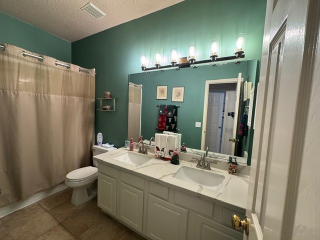 9918 Mossy Tree Lane Houston, TX 77064 - Photo 7 of 15 a bathroom with a double vanity sink toilet and a mirror