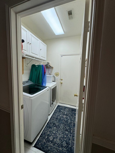 9918 Mossy Tree Lane Houston, TX 77064 - Photo 8 of 15 a utility room with cabinets washer and dryer