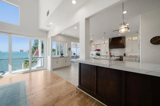 a kitchen with granite countertop a sink stainless steel appliances and lots of counter space