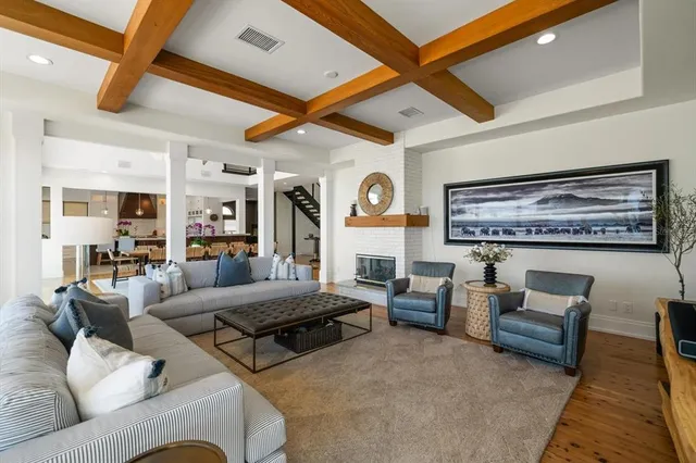 a bathroom with a granite countertop sink a toilet a mirror and shower