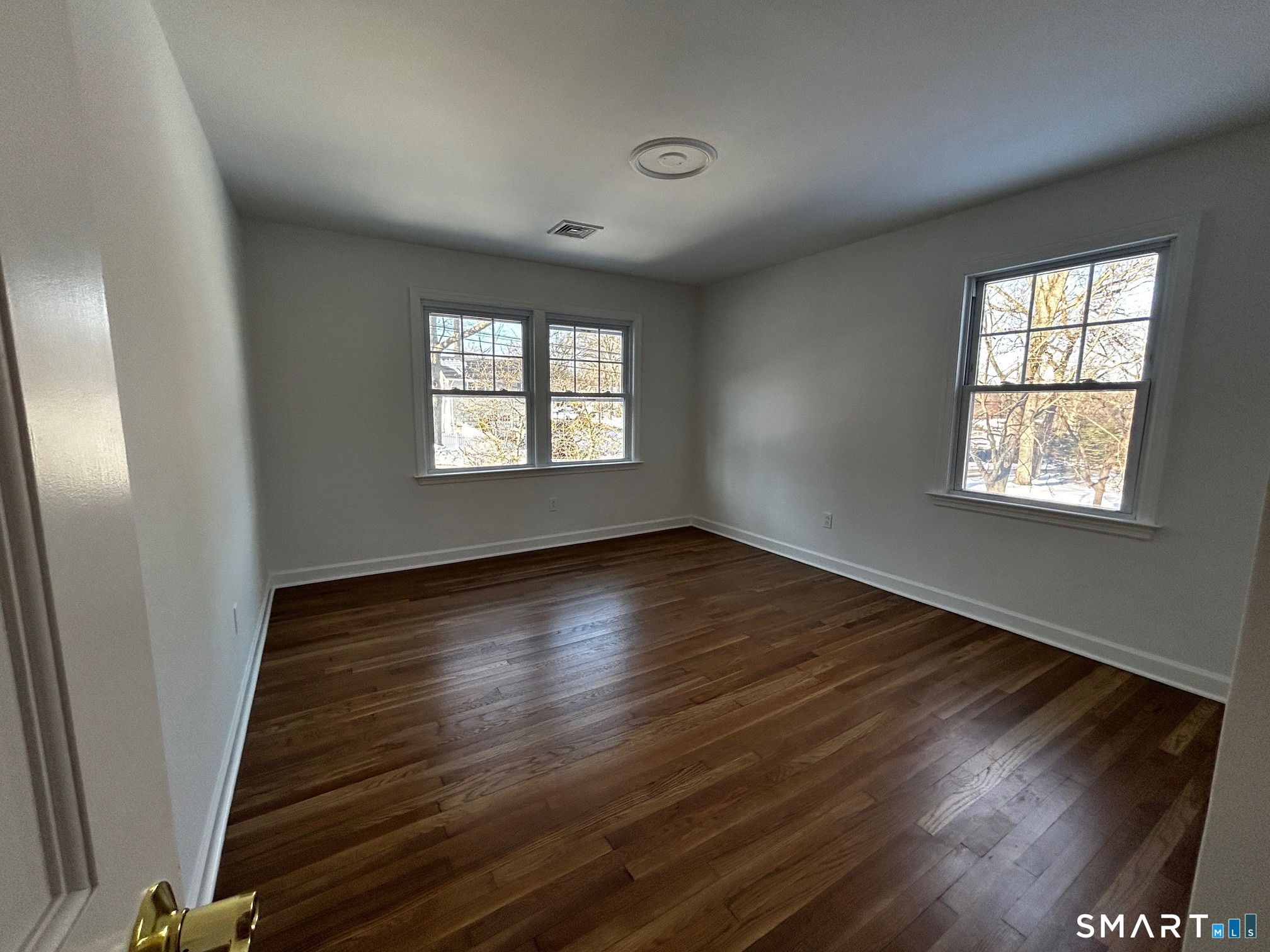 97 Godfrey Road Fairfield, CT 06825 - Photo 14 of 26 a view of an empty room with wooden floor and a window