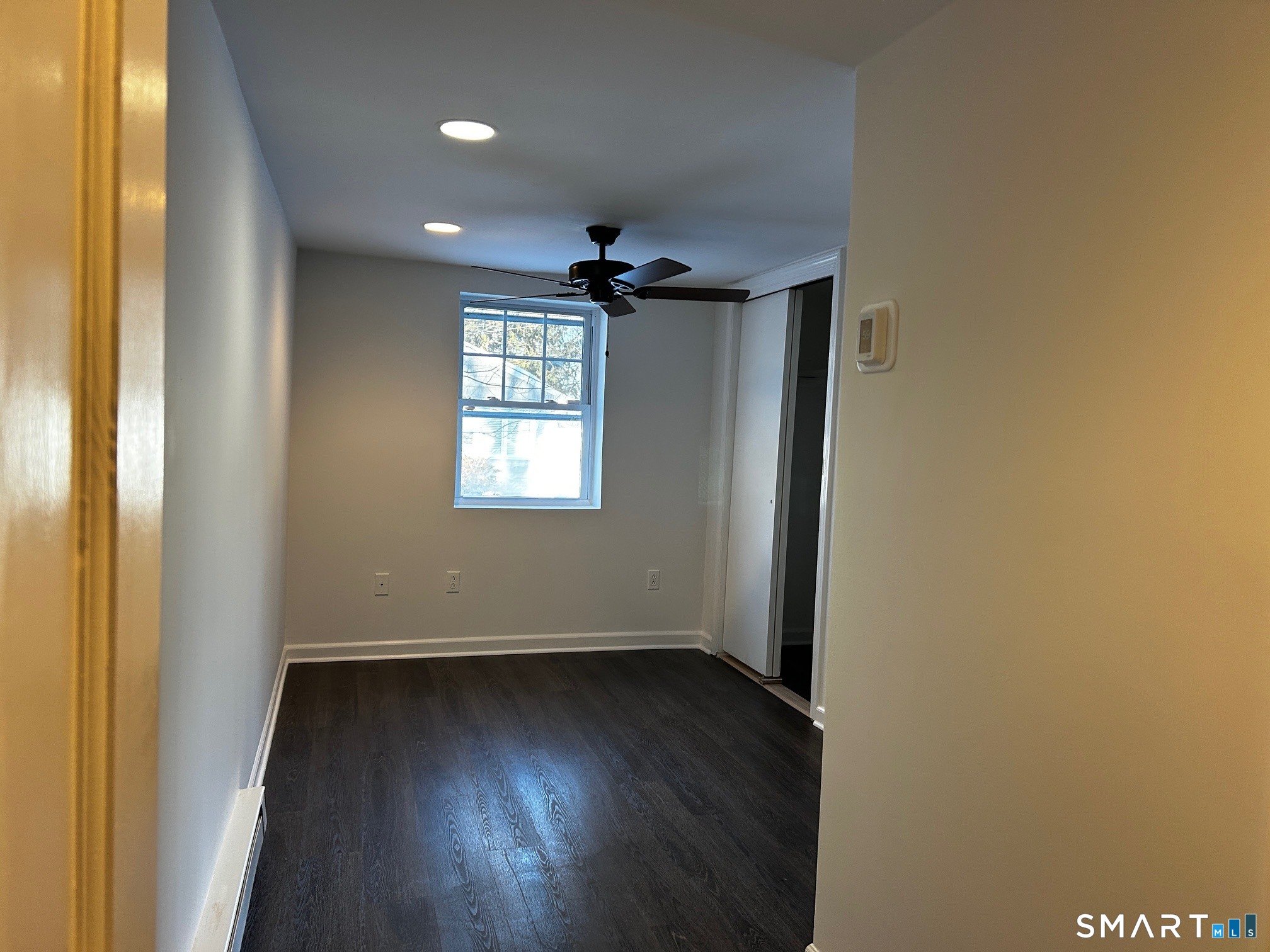 97 Godfrey Road Fairfield, CT 06825 - Photo 21 of 26 an empty room with wooden floor and windows