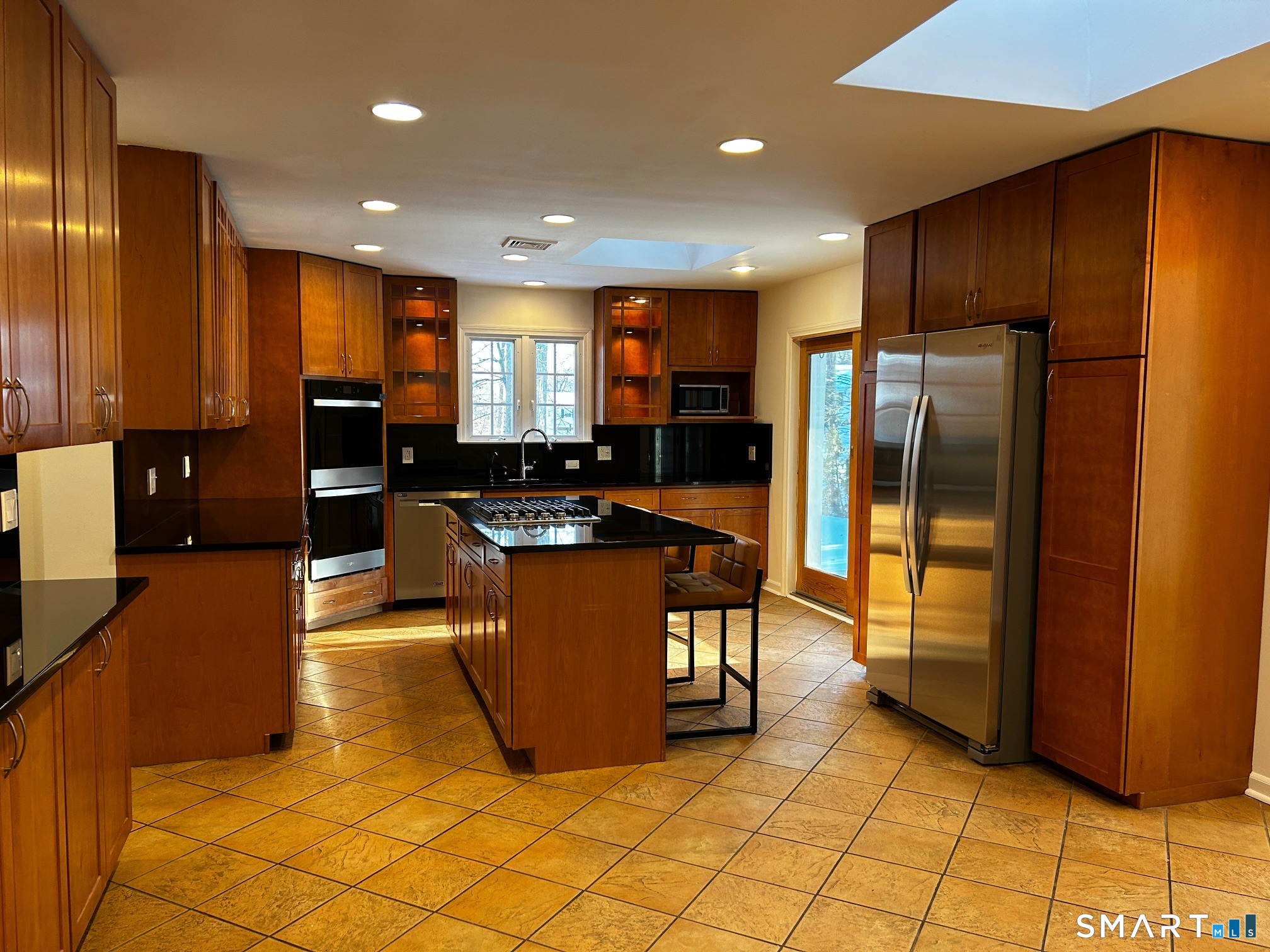 97 Godfrey Road Fairfield, CT 06825 - Photo 7 of 26 a kitchen with stainless steel appliances granite countertop a refrigerator and a stove