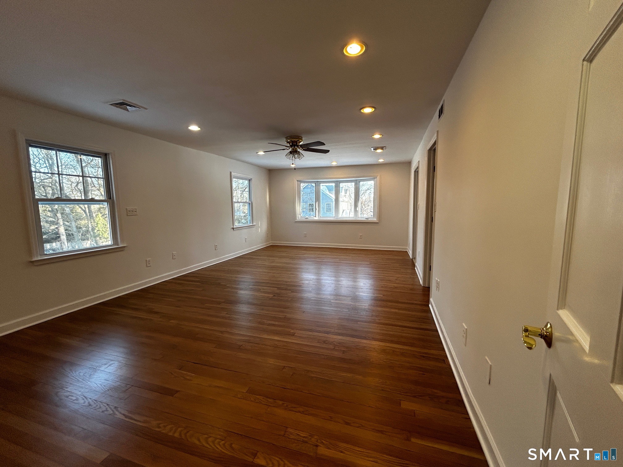 97 Godfrey Road Fairfield, CT 06825 - Photo 9 of 26 an empty room with wooden floor and windows