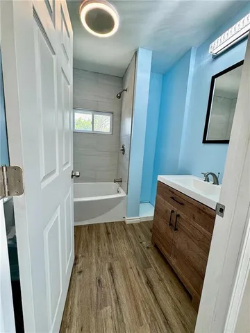 a bathroom with a sink a mirror and shower