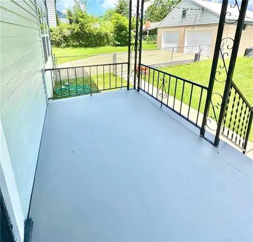 a view of balcony with wooden floor