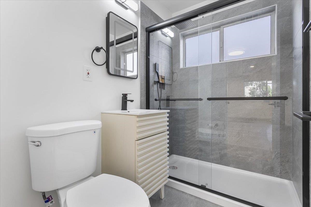 1610 Milvia Street Berkeley, CA 94709 - Photo 14 of 24 a bathroom with a toilet and a shower