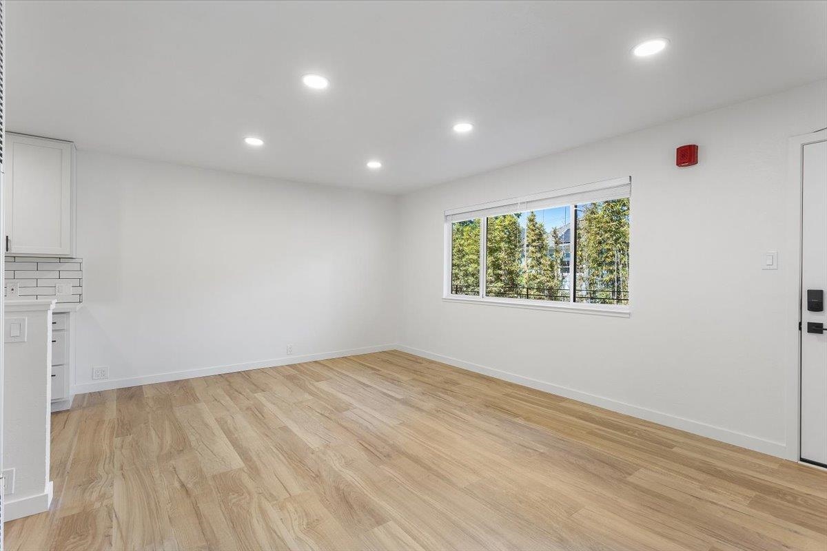 1610 Milvia Street Berkeley, CA 94709 - Photo 10 of 24 an empty room with wooden floor and windows