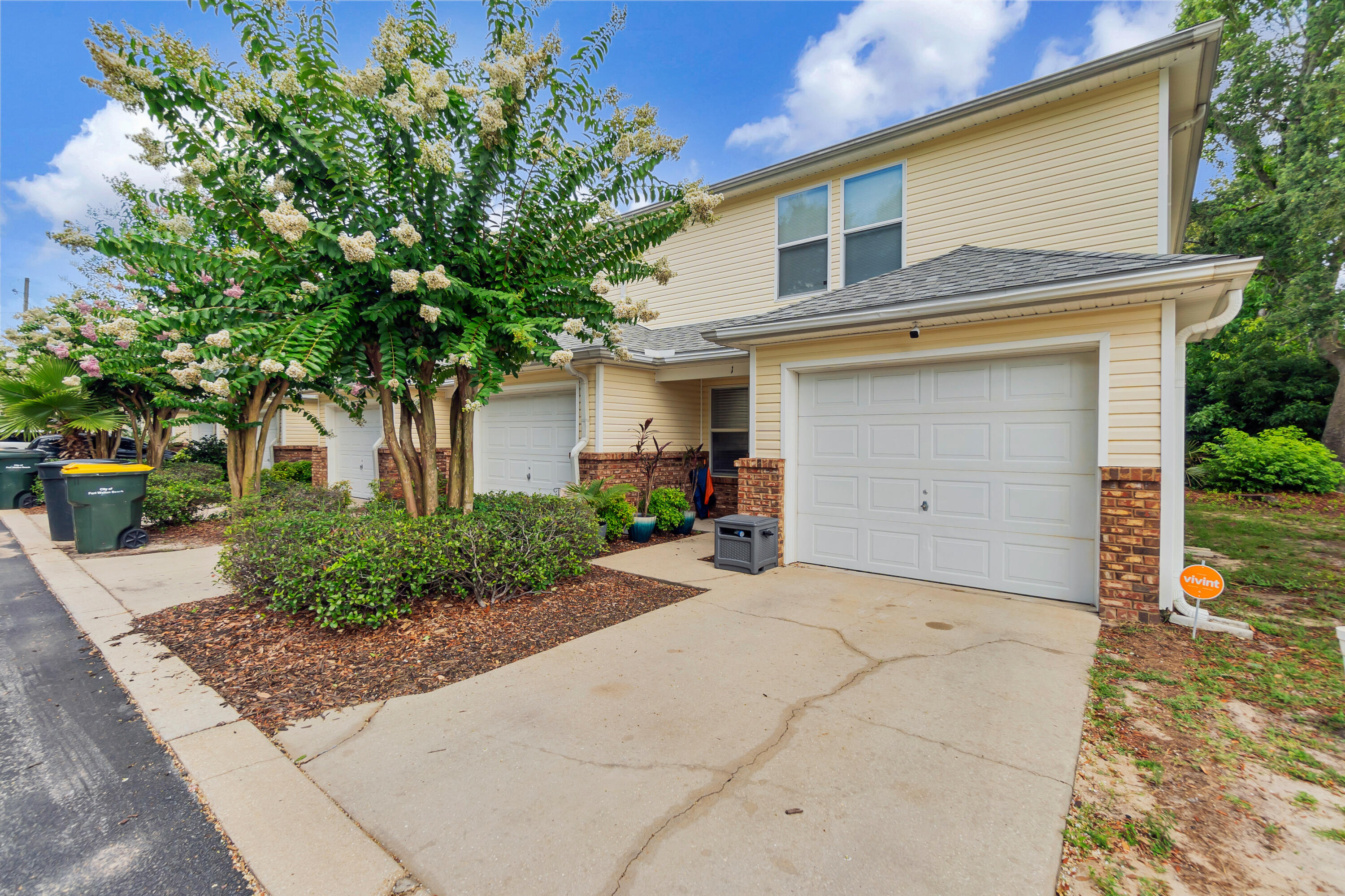 a view of a house with a tree in the background