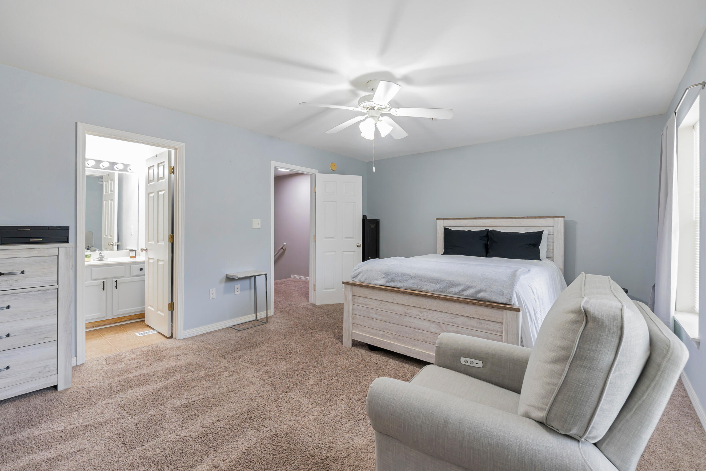 17 Southeast Shell Avenue, Unit C1 Fort Walton Beach, FL 32548 - Photo 15 of 24 a bedroom with a large bed and a chandelier fan