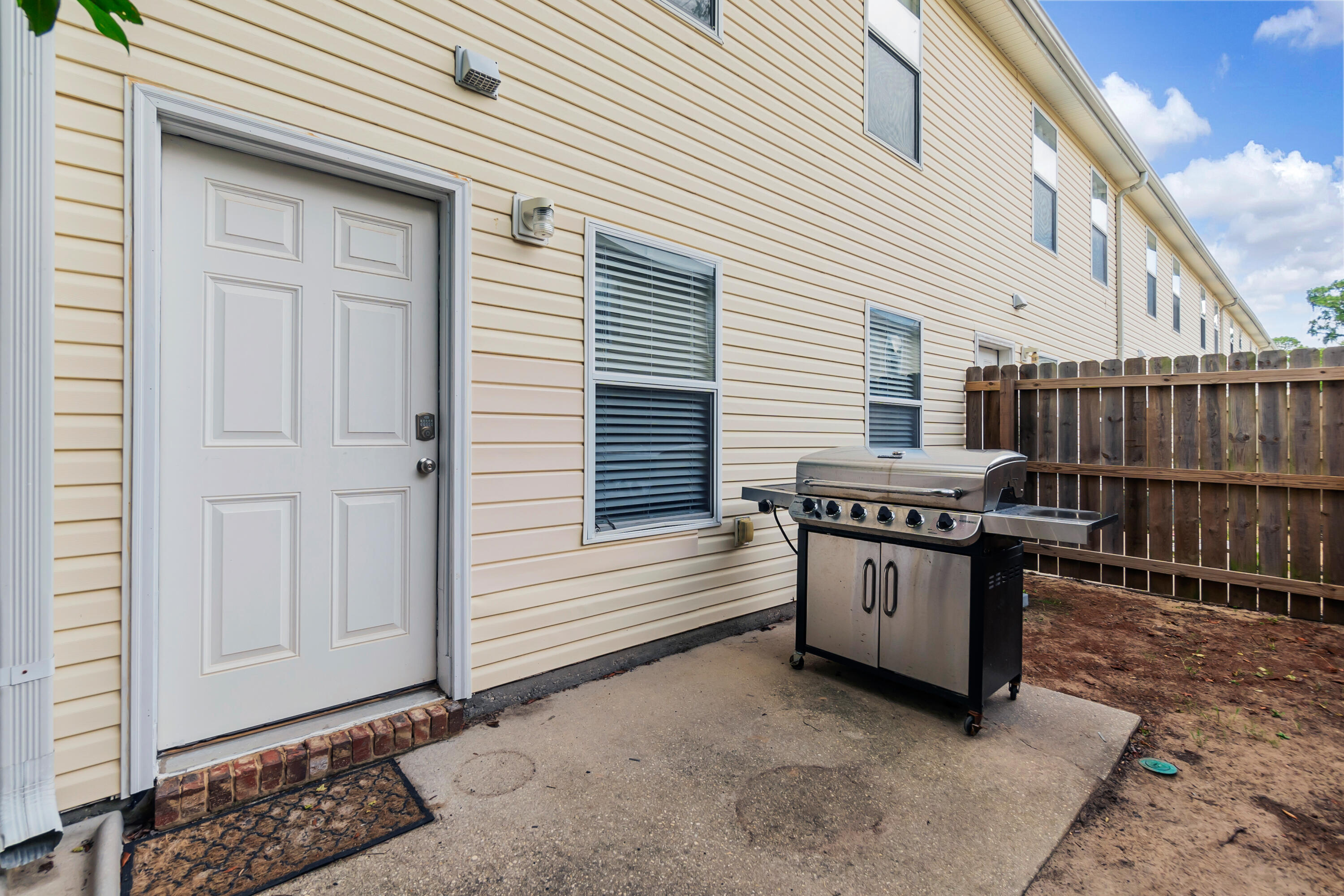 17 Southeast Shell Avenue, Unit C1 Fort Walton Beach, FL 32548 - Photo 24 of 24 a view of a house with barbeque and wooden fence
