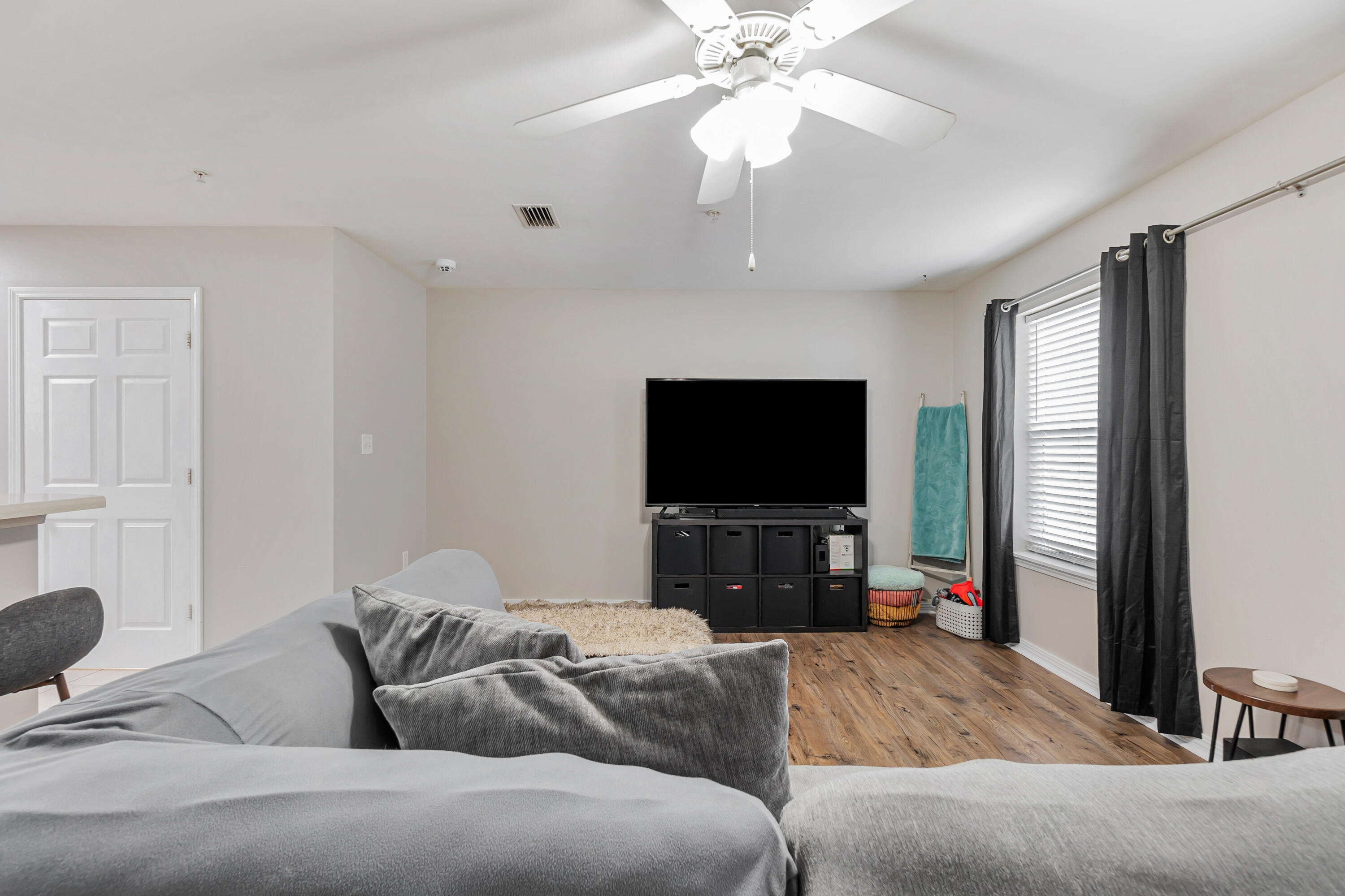 17 Southeast Shell Avenue, Unit C1 Fort Walton Beach, FL 32548 - Photo 6 of 24 a living room with furniture and a flat screen tv