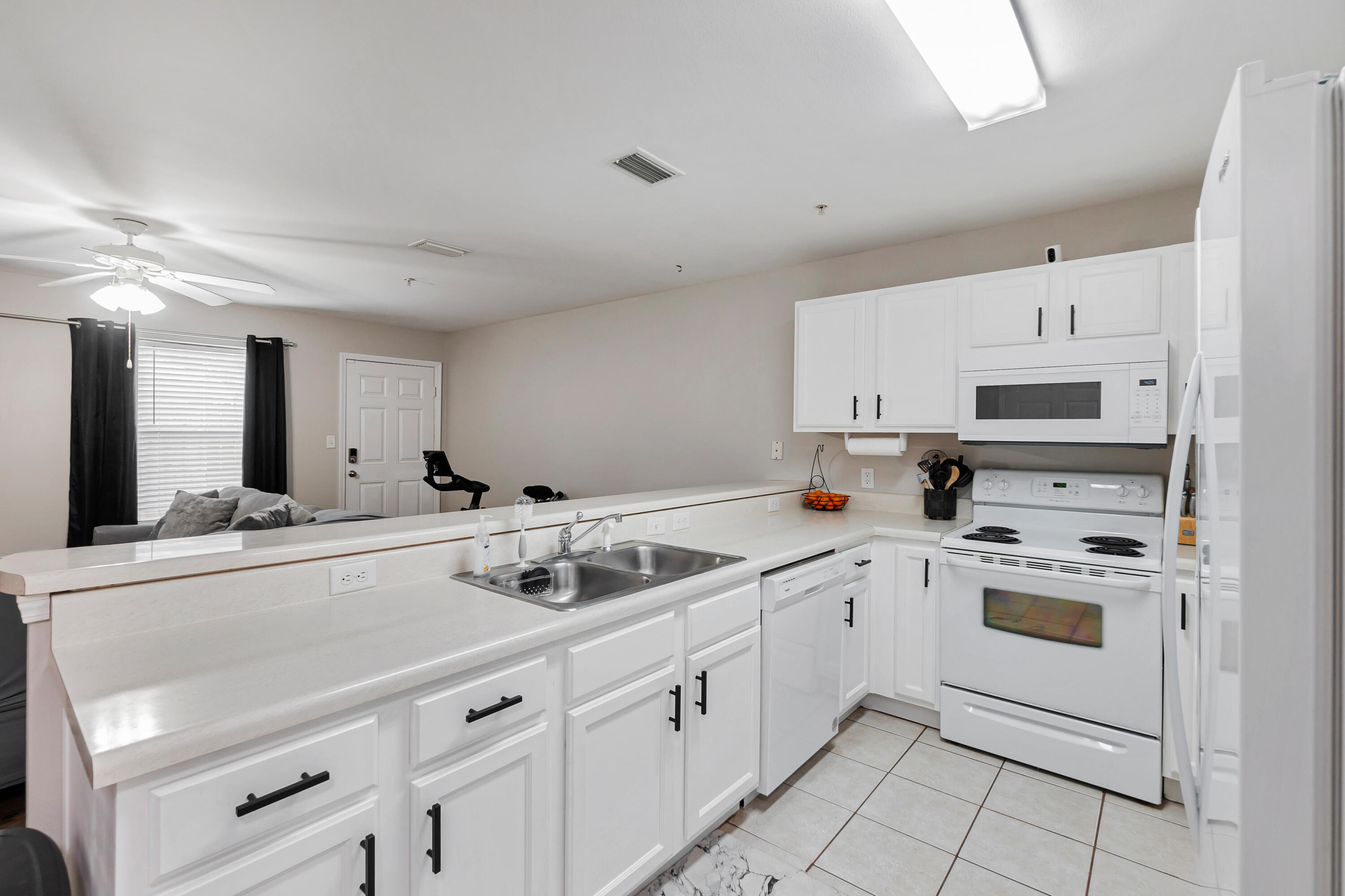 17 Southeast Shell Avenue, Unit C1 Fort Walton Beach, FL 32548 - Photo 7 of 24 a kitchen with appliances a sink and cabinets