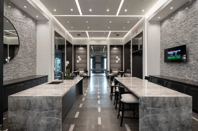 a large hall with stainless steel appliances granite countertop a granite counter tops and a view of living room