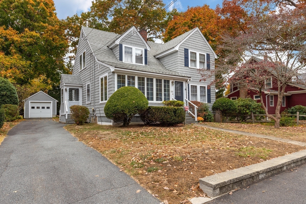 103 Madison Street Dedham, MA 02026 - Photo 1 of 21 a front view of a house with a yard and garage