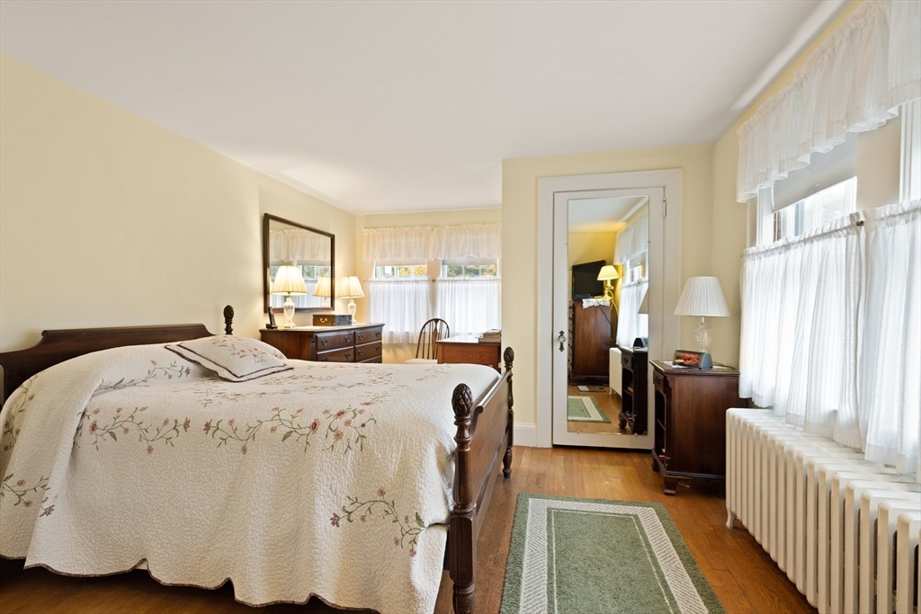 103 Madison Street Dedham, MA 02026 - Photo 11 of 21 a bedroom with a bed and wooden floor