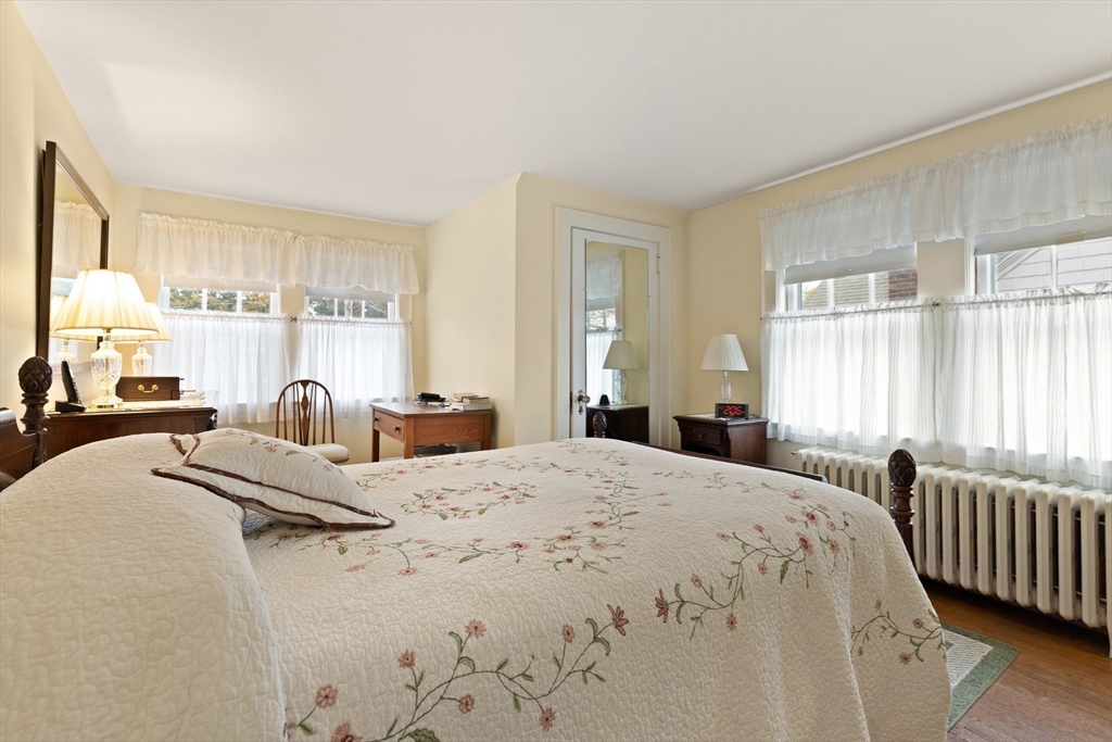 103 Madison Street Dedham, MA 02026 - Photo 12 of 21 a large bedroom with a bed and large windows