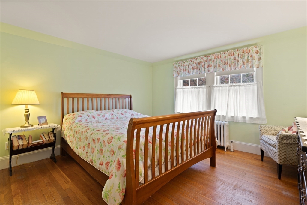 103 Madison Street Dedham, MA 02026 - Photo 13 of 21 a bed sitting in a bedroom next to a window