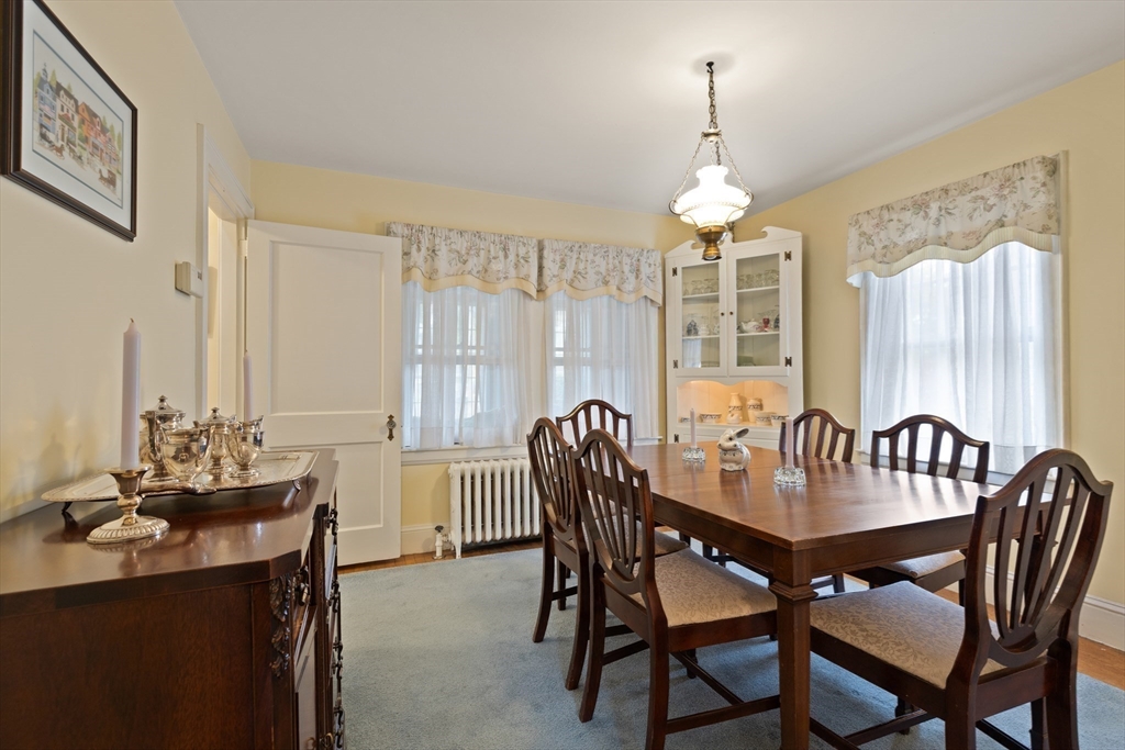 103 Madison Street Dedham, MA 02026 - Photo 6 of 21 a dining room with furniture a chandelier and window