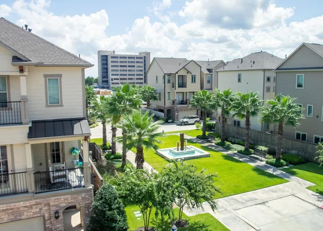 a view of a house with swimming pool and sitting area